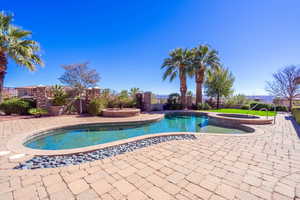 Relaxing pool / spa with a fenced backyard and a patio