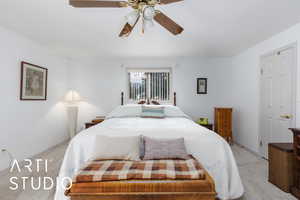 Primary bedroom featuring carpet and a ceiling fan & walk-in closet