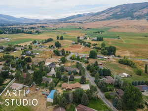 Aerial view of property's location featuring a mountain backdrop and rural landscape