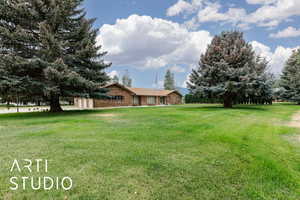 View of the front of home with a grassy yard
