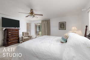 Primary bedroom with ceiling fan with access to patio and primary bathroom