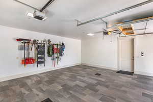 Garage with a garage door opener and baseboards