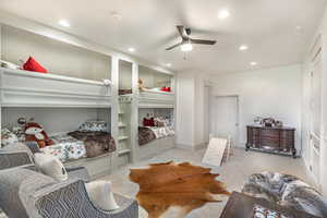 Bedroom with light colored carpet, recessed lighting, and a ceiling fan