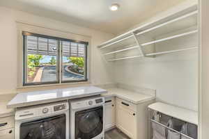 Laundry area with washing machine and clothes dryer and cabinet space