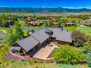 Aerial view of property and surrounding area featuring a mountain backdrop