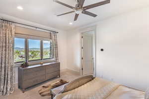 Bedroom featuring a mountain view, light carpet, a ceiling fan, and recessed lighting