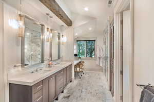 Full bathroom featuring double vanity, vaulted ceiling with beams, recessed lighting, and a marble finish shower