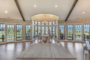 Dining room featuring dark wood-style floors and suspended lighting
