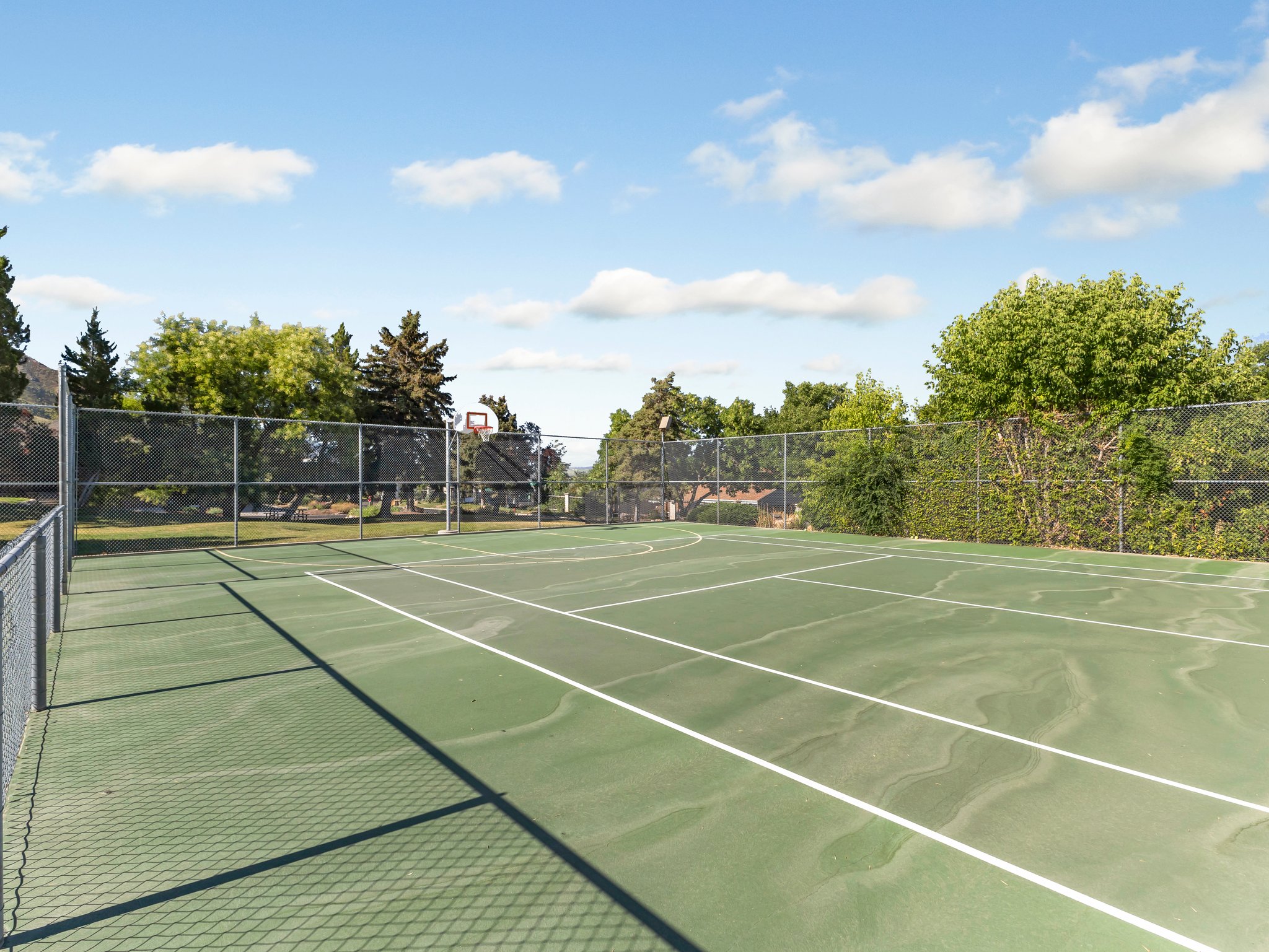 View of tennis court featuring community basketball court