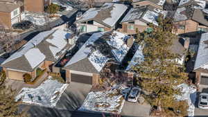 View of home's exterior with a garage, concrete driveway, brick siding, and a patio area