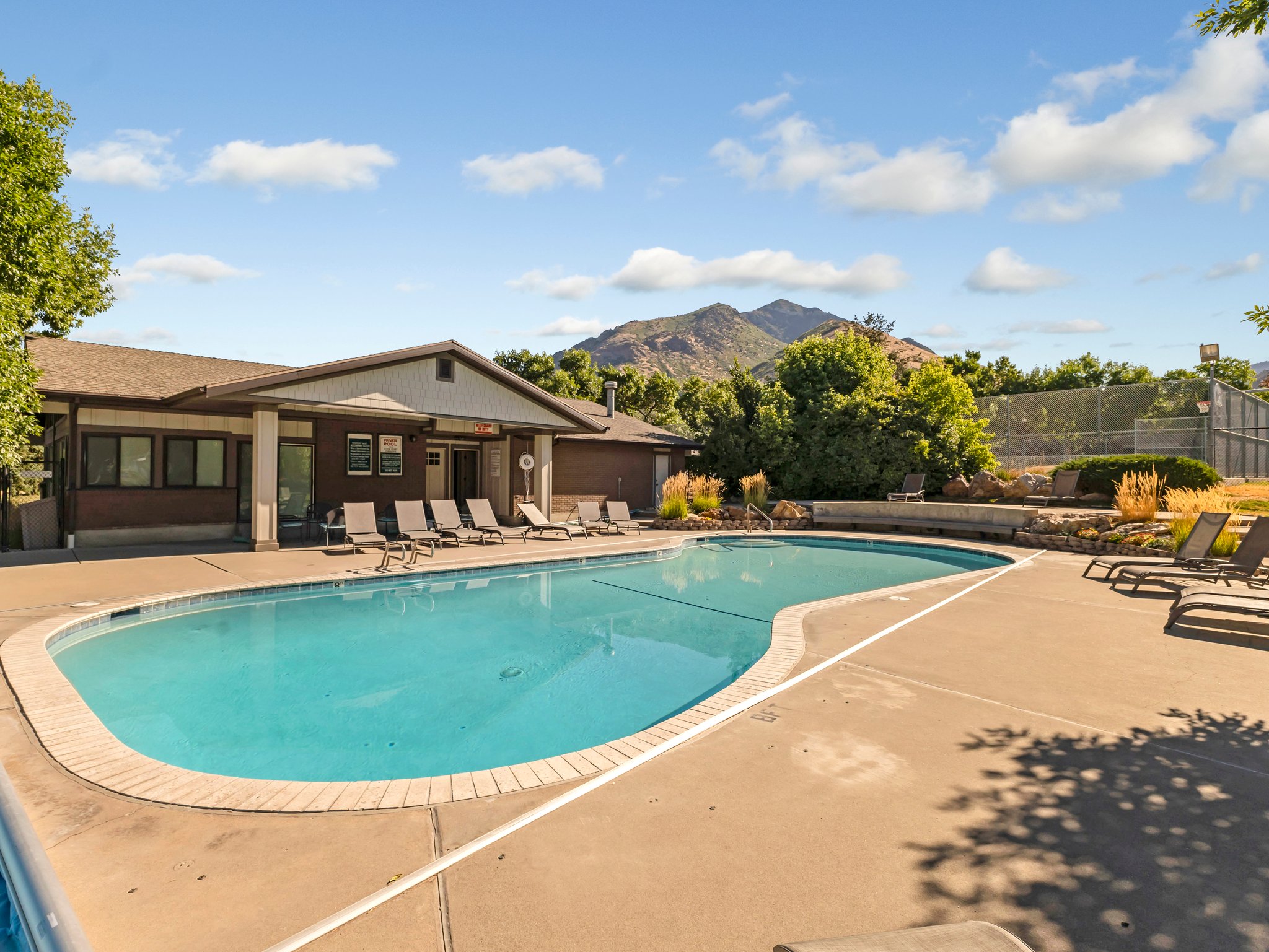 Community pool featuring a patio and a mountain view