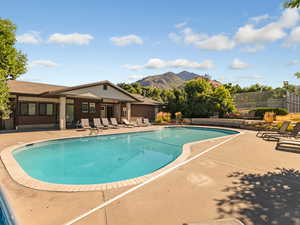 Community pool featuring a patio and a mountain view