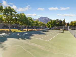 View of tennis court with a mountain view