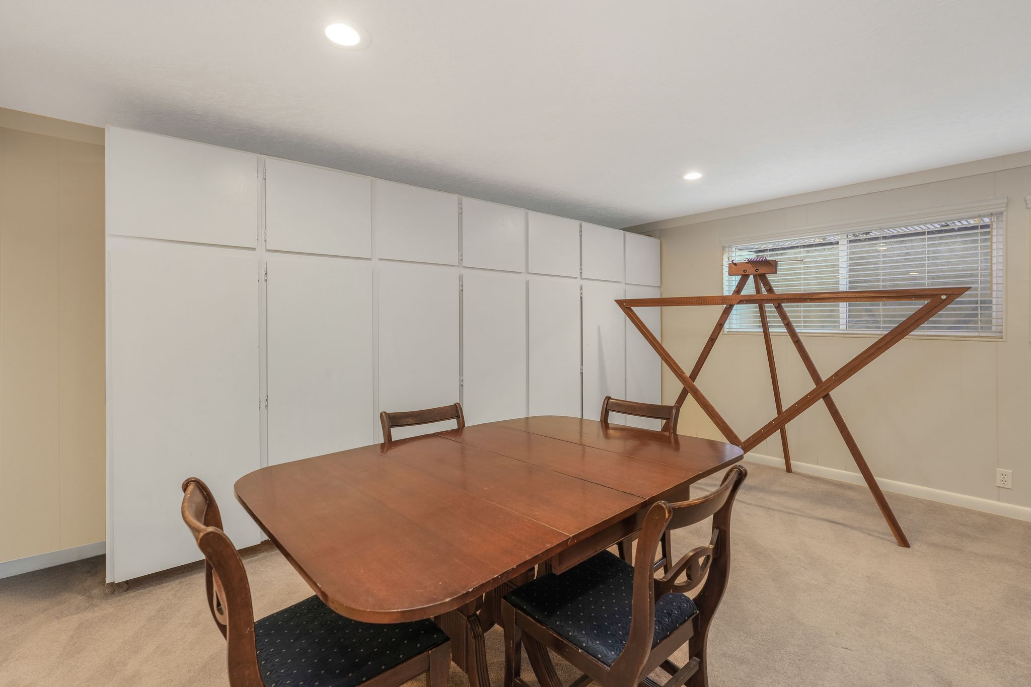Living area with a fireplace, recessed lighting, and vaulted ceiling with beams