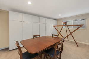 Living area with a fireplace, recessed lighting, and vaulted ceiling with beams