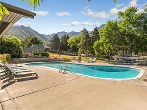 Community pool featuring a patio and a mountain view