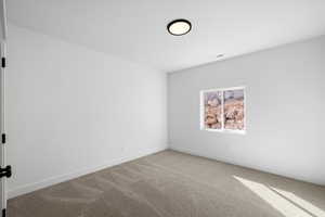 Unfurnished room with light carpet and baseboards