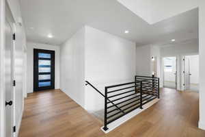 Foyer featuring light wood finished floors and recessed lighting