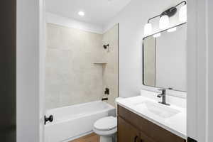 Full bathroom featuring vanity, washtub / shower combination, and recessed lighting