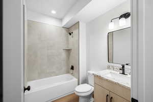 Full bath featuring vanity, bathtub / shower combination, recessed lighting, and light wood-style flooring