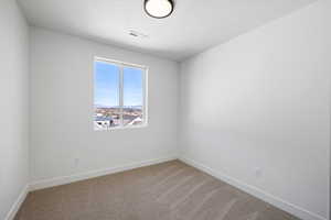 Carpeted empty room with baseboards