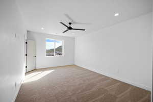 Unfurnished room featuring light colored carpet, ceiling fan, and recessed lighting