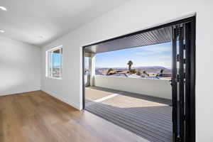 Unfurnished room with a mountain view and light wood-style floors