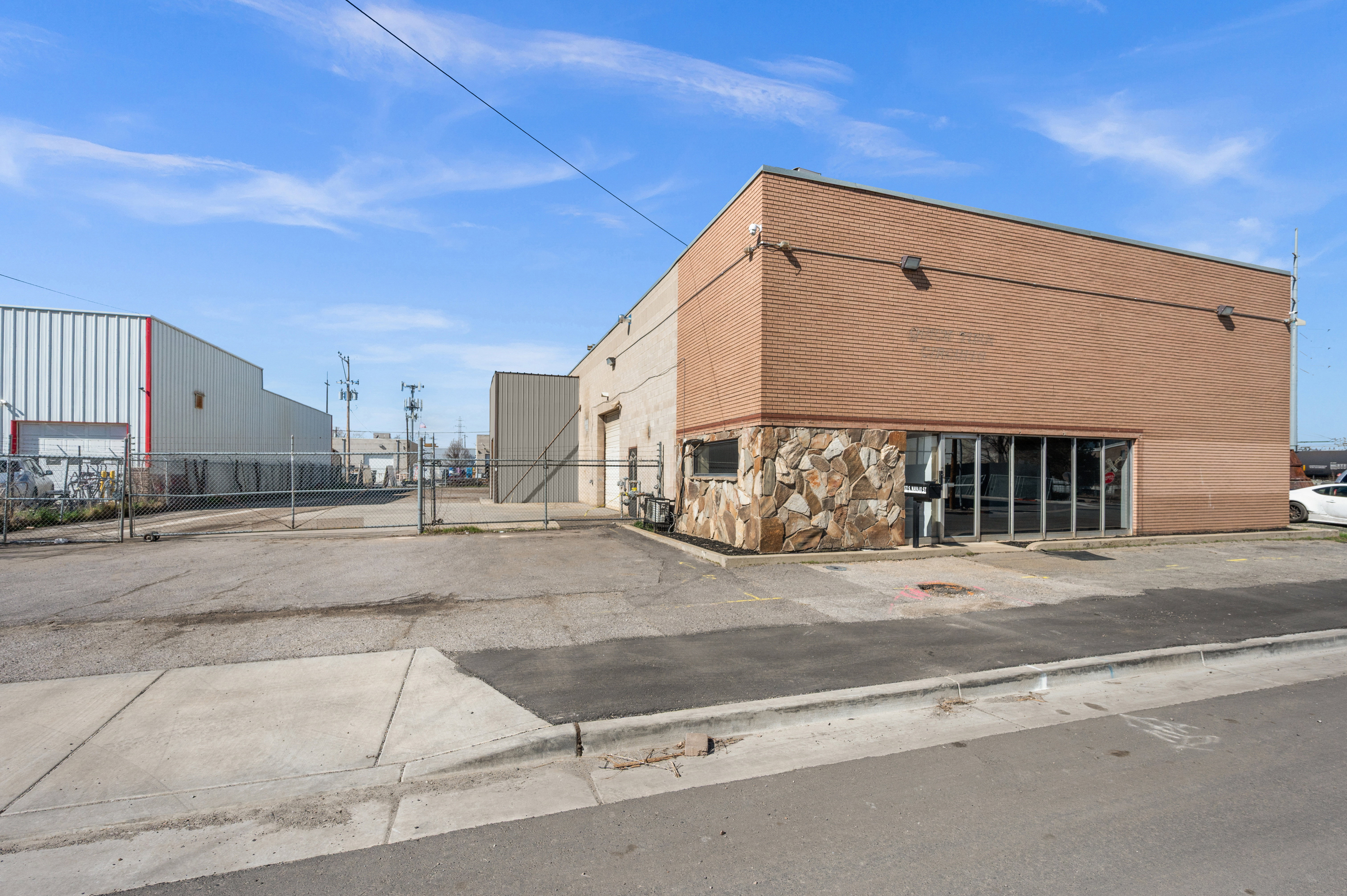 View of commercial property featuring uncovered parking