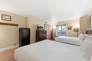 Bedroom featuring access to outside and light wood-type flooring