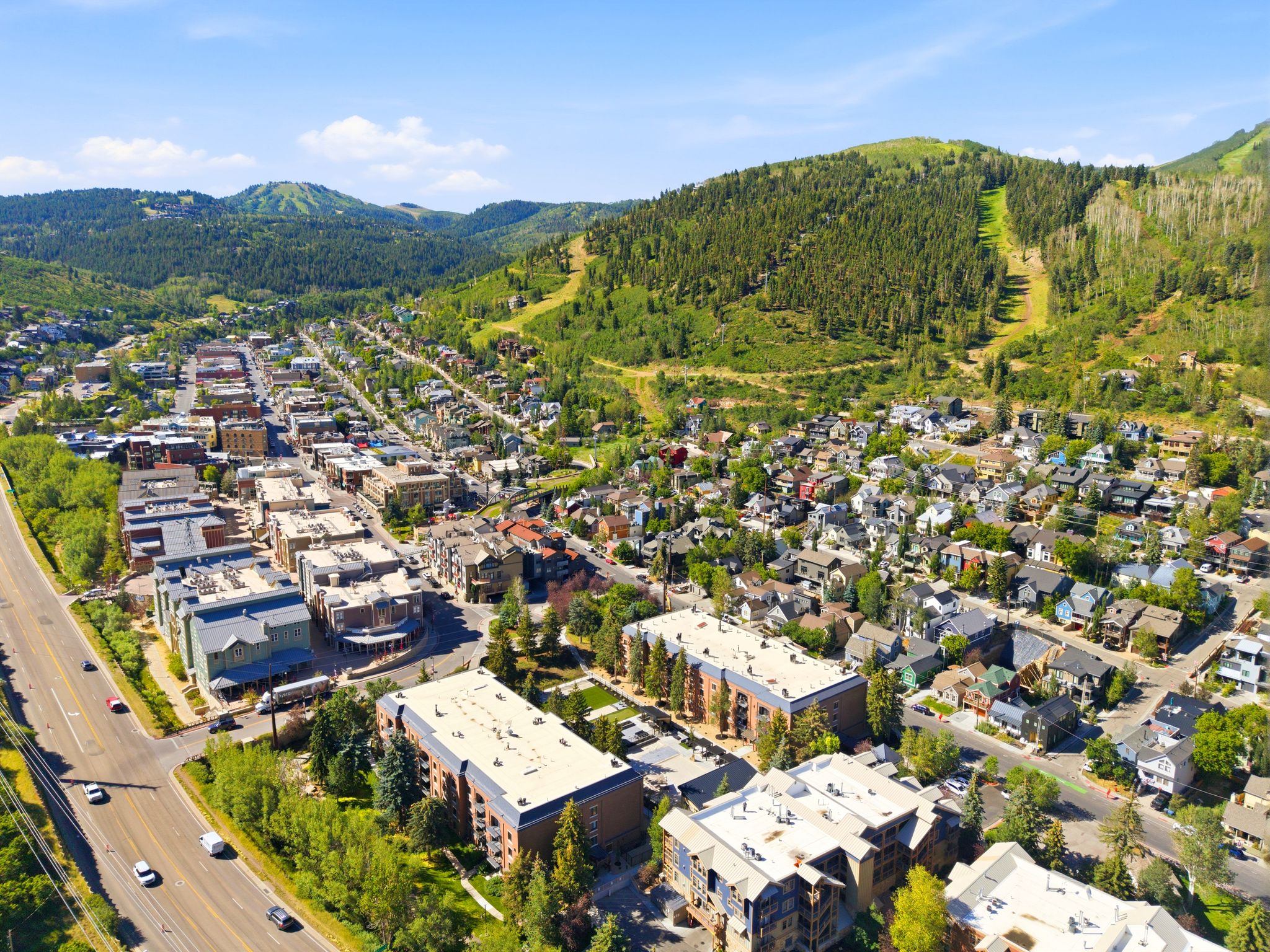 Aerial perspective showcasing a vibrant community nestled among verdant mountains