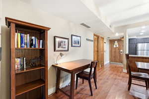 Dining space featuring wood finished floors and recessed lighting