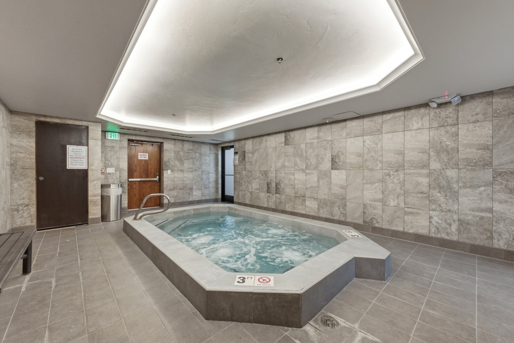View of pool with a hot tub
