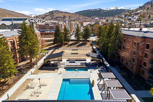 Community pool featuring a mountain view and a patio area