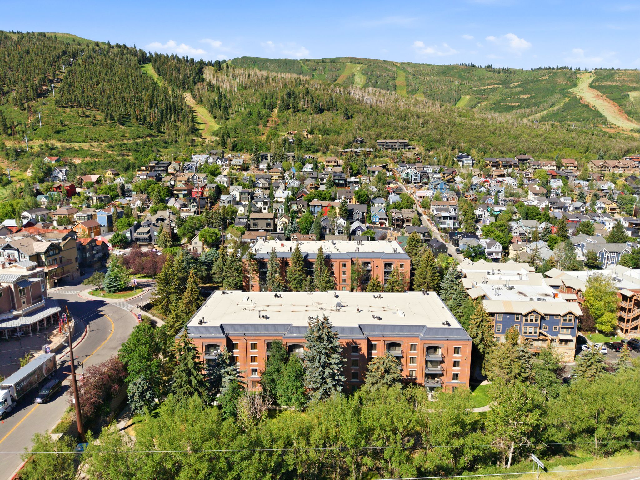 Townhome-style building featuring brick facade, multiple levels, and private balconies
