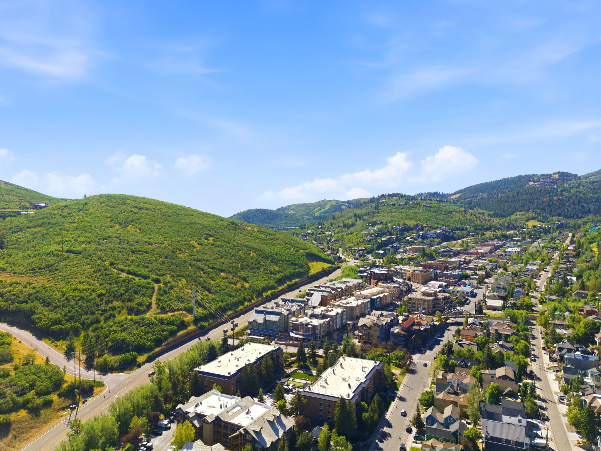 Aerial perspective showcasing a vibrant community nestled among verdant hillsides