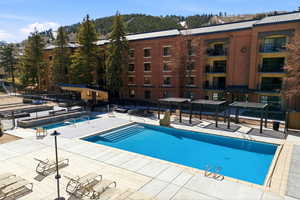 Community pool with a patio