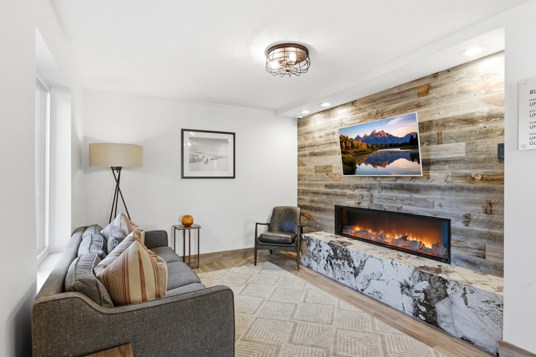 Living room featuring a fireplace, light wood-style floors, and recessed lighting