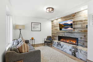 Living room featuring a fireplace, light wood-style floors, and recessed lighting