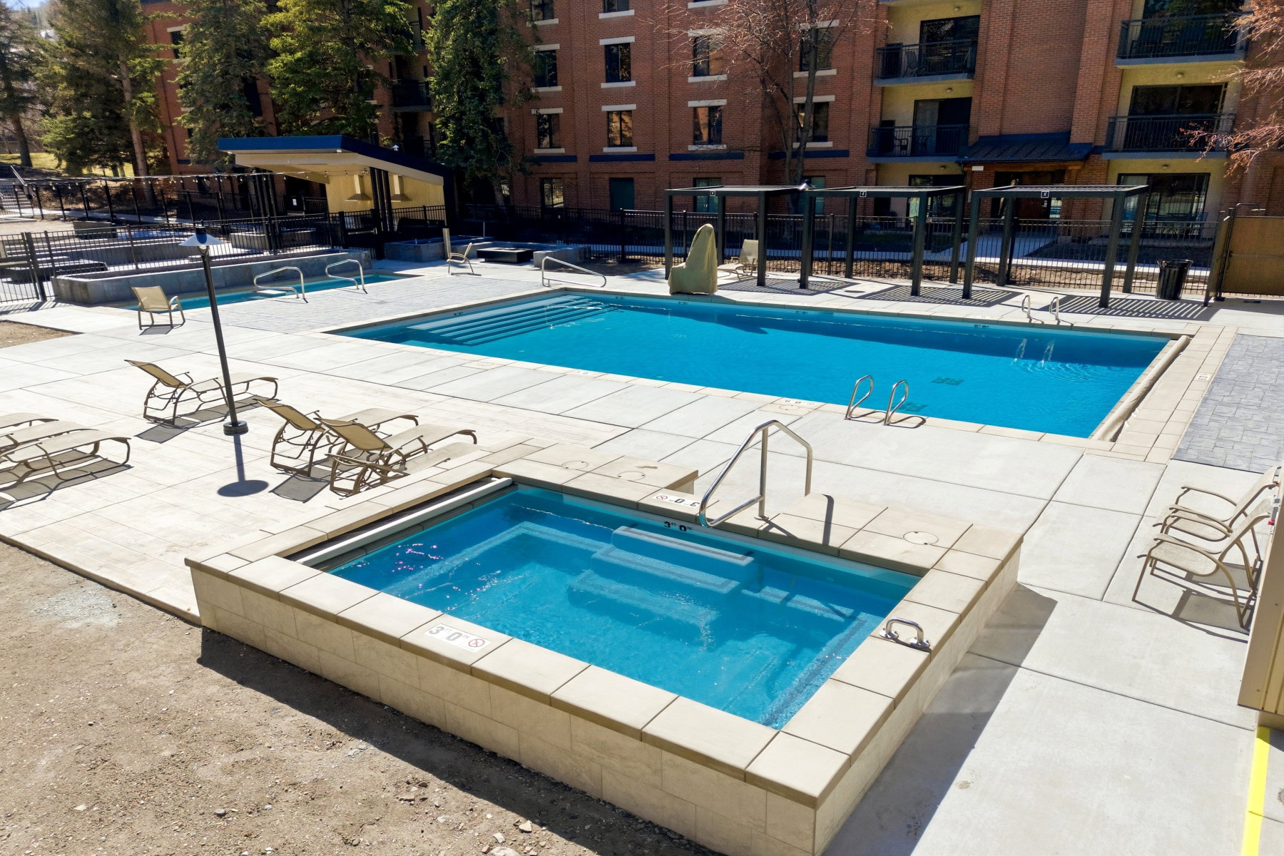 Community pool featuring a patio area and a hot tub