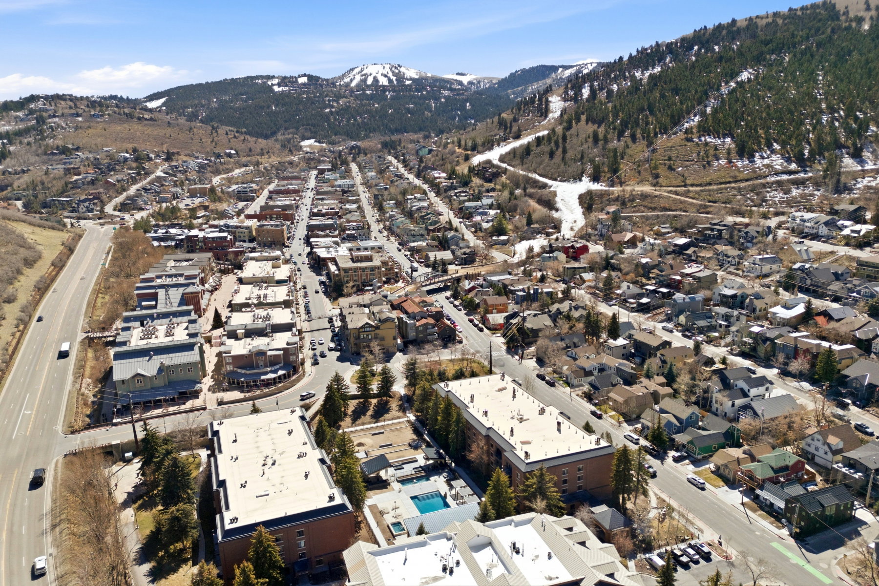 Aerial view of property and surrounding area featuring mountains