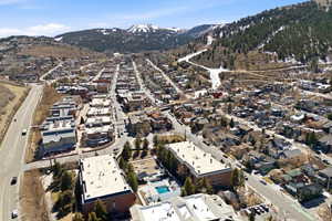 Aerial view of property and surrounding area featuring mountains