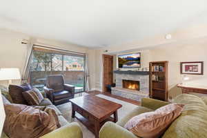 Living room with a fireplace and wood finished floors