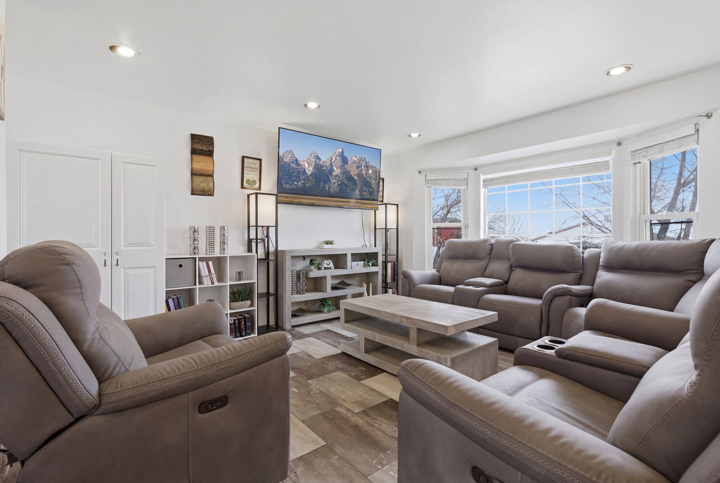 Updated bright living room with can lights and lots of natural light.