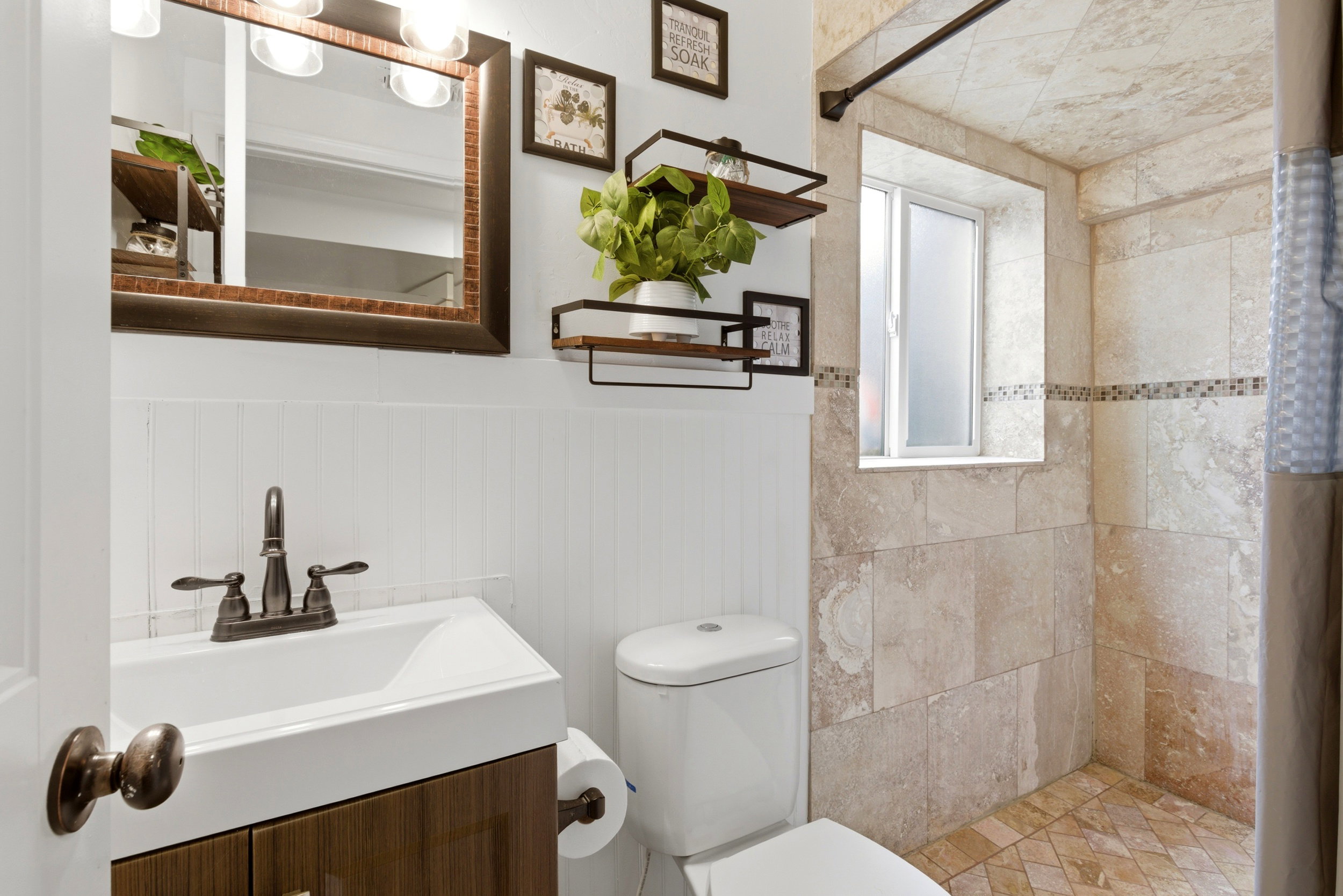 Updated lower level three-quarter bath with oversized shower.