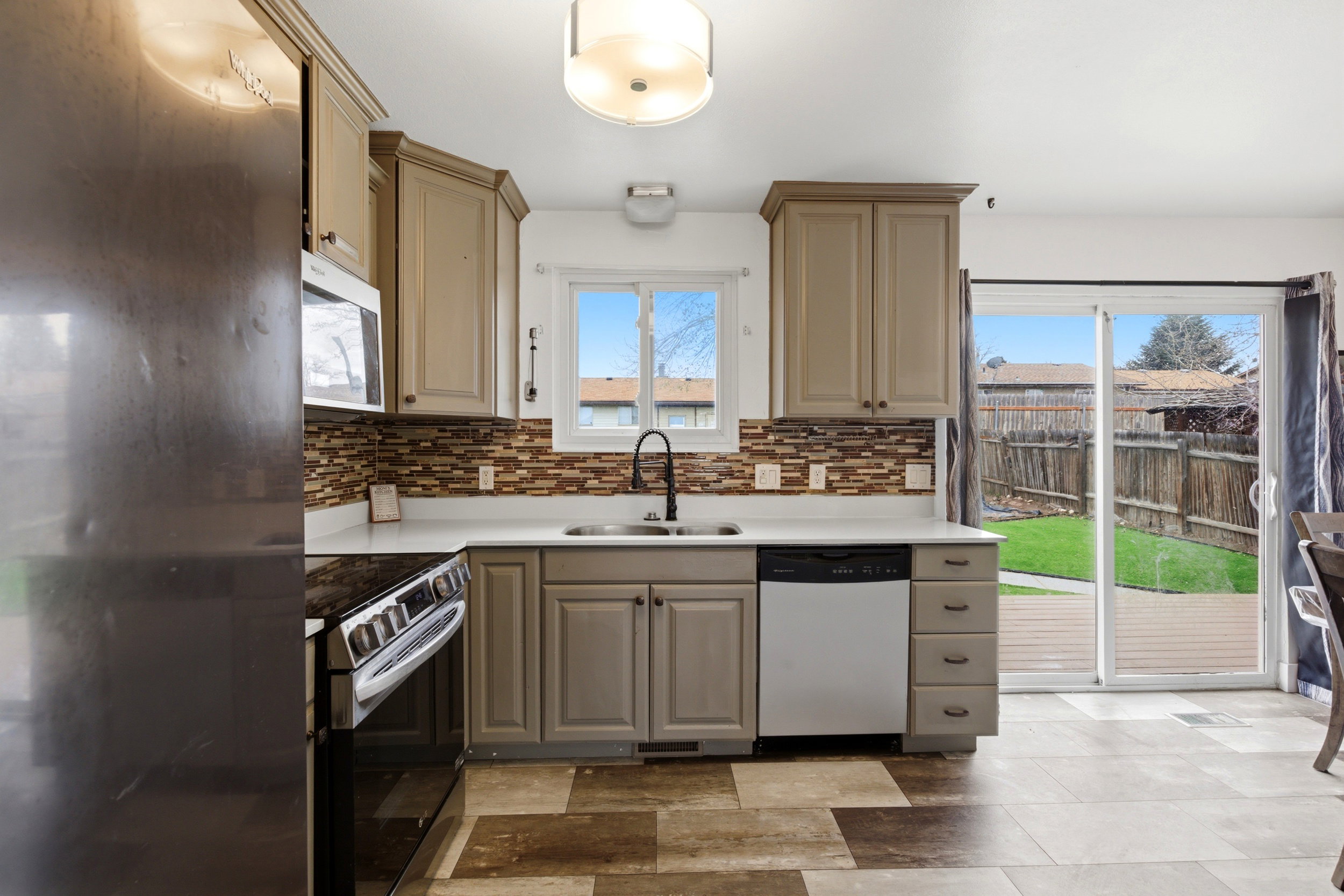 Updated Kitchen featuring stainless steel appliances and quartz countertops