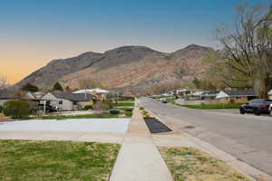 View of asphalt street with a residential view and a mountain view