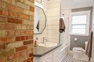 Full bath featuring vanity and  shower combination