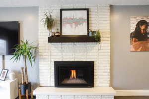 Detailed view of a fireplace and baseboards