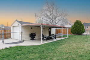 Back of house at dusk with a patio area