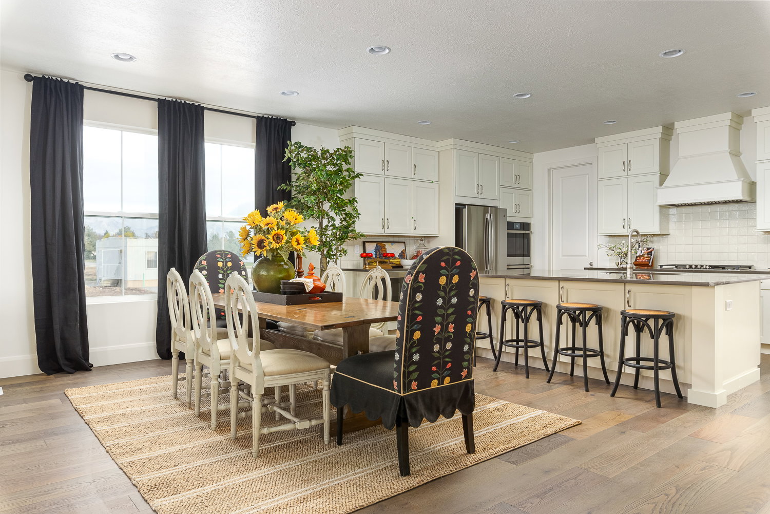 Dining space with light wood-style floors and recessed lighting